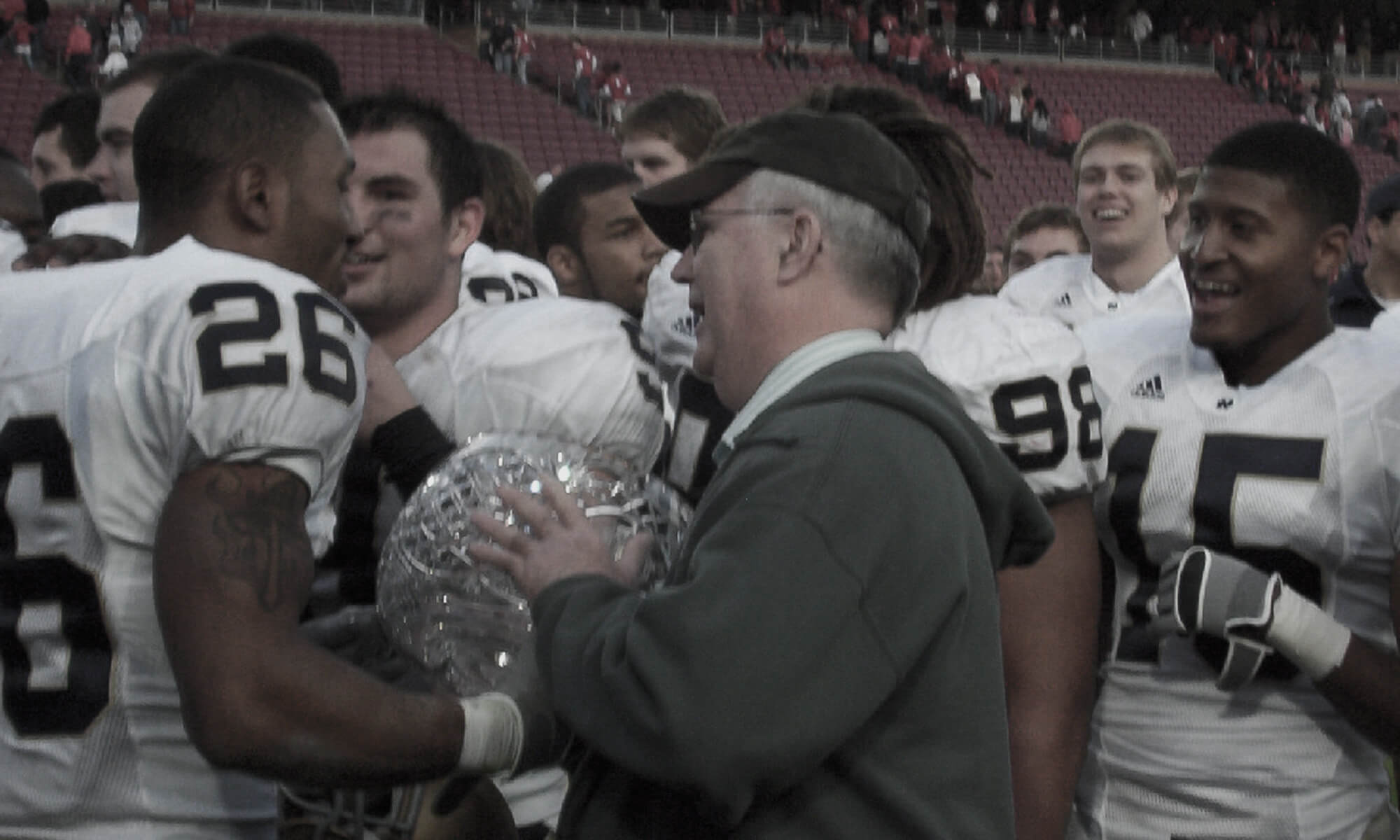 Stanford Football team celebrating with The Legends Trophy